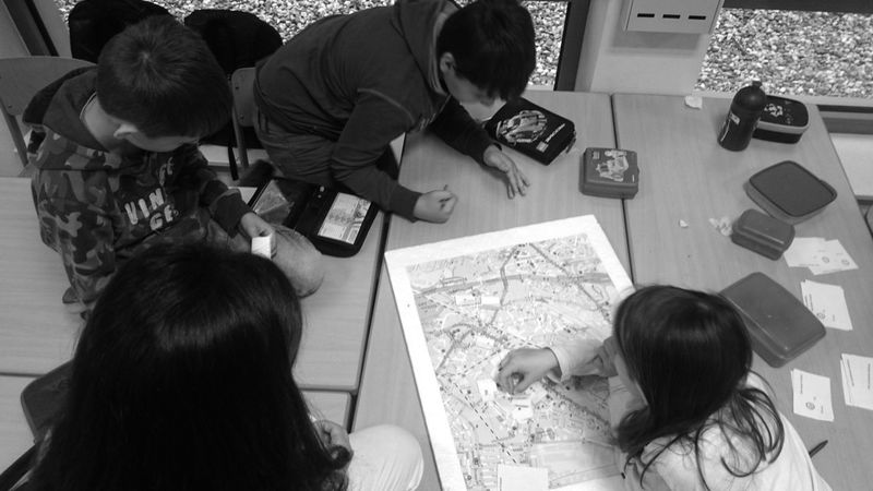 Schülerinnen und Schüler setzen Nadeln auf dem Stadtplan