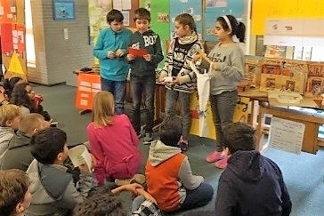 Schülerinnen und Schüler halten ein Referat
